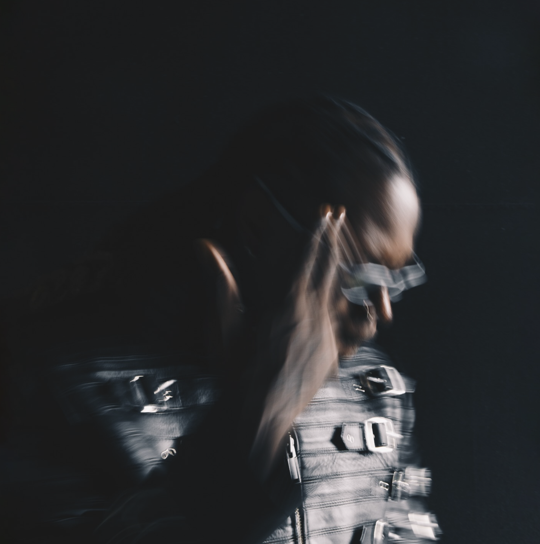 RudeboyFinesse in profile, leather jacket, grill flashing